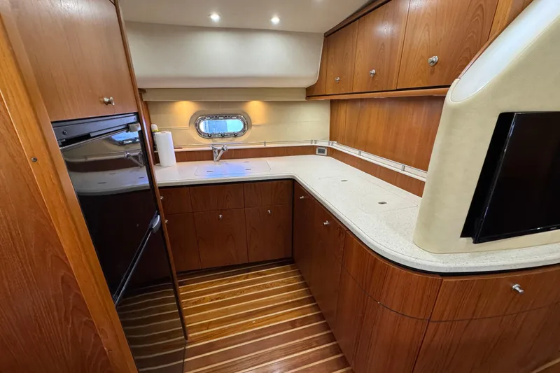 Slide: The Image of Luxurious 2007 Tiara 43 yacht kitchen with wood cabinetry and modern appliances. - 15