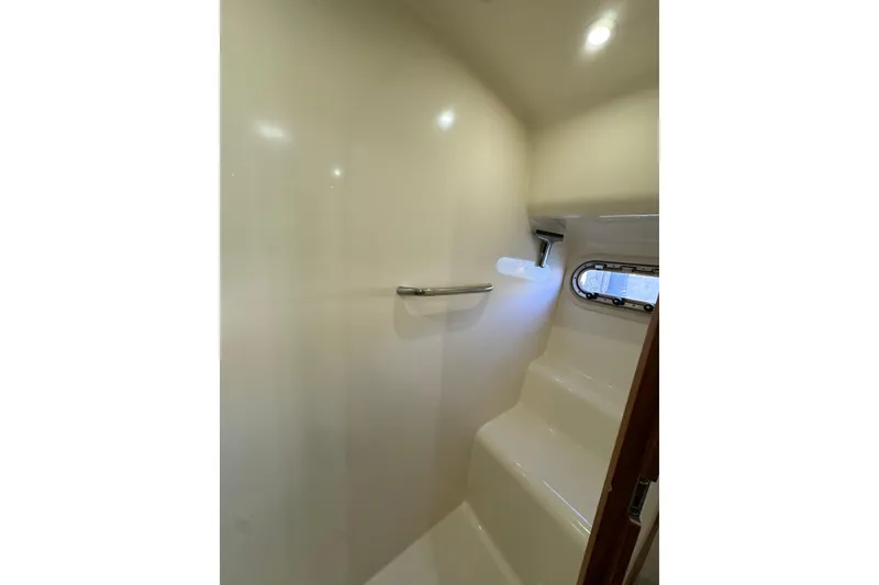 Slide: The Image of 2007 Tiara 43 yacht interior shower with porthole and sleek design. - 2