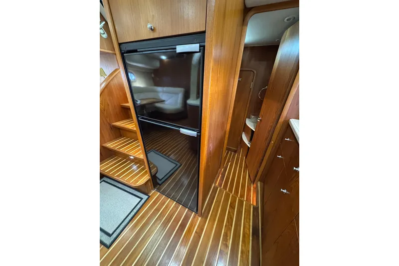 Slide: The Image of 2007 Tiara 43 yacht interior with wooden flooring and cabinetry. - 23