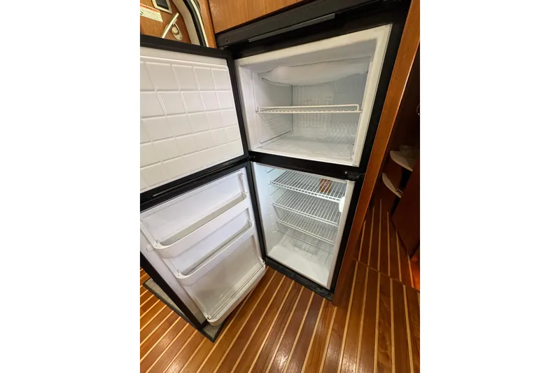 Slide: The Image of Open refrigerator in 2007 Tiara 43 yacht, showcasing spacious interior and wooden flooring. - 24