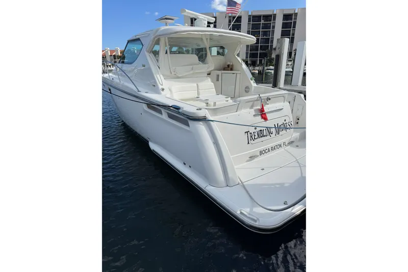 Slide: The Image of 2007 Tiara 43 yacht docked, featuring sleek white design and spacious deck. - 26