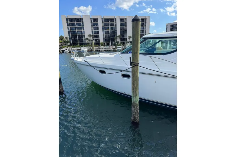 Slide: The Image of 2007 Tiara 43 yacht docked in marina with waterfront buildings in background. - 27