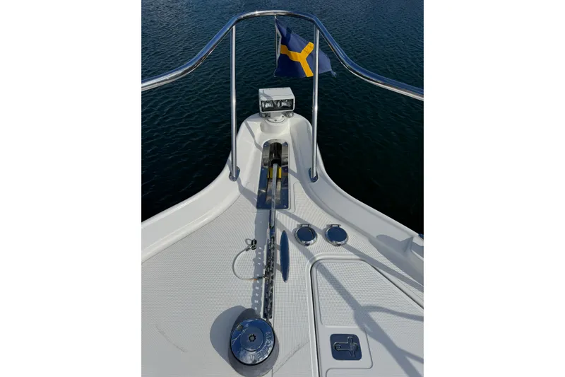 Slide: The Image of Bow of 2007 Tiara 43 yacht with anchor and flag on calm water. - 30