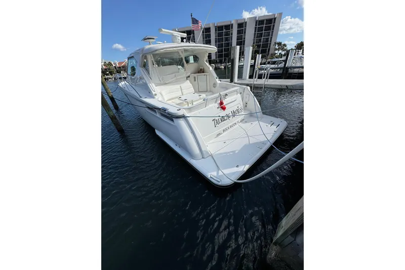 Slide: The Image of 2007 Tiara 43 yacht docked in marina, featuring sleek design and spacious deck. - 32