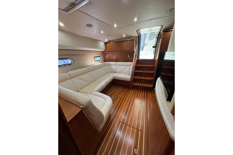 Slide: The Image of Luxurious interior of 2007 Tiara 43 yacht with elegant wood flooring and plush seating. - 35