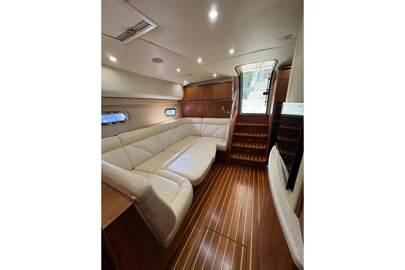 Slide: The Image of Luxurious interior of a 2007 Tiara 43 yacht with elegant wood flooring and plush seating. - 37