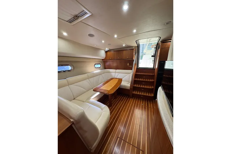 Slide: The Image of Luxurious interior of a 2007 Tiara 43 yacht with elegant wood finishes and plush seating. - 38