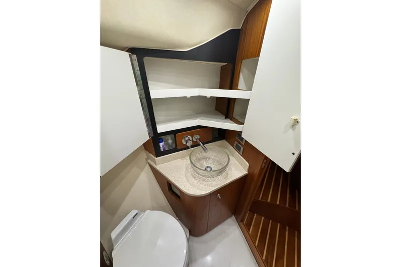 Slide: The Image of 2007 Tiara 43 yacht bathroom with modern sink, toilet, and wooden cabinetry. - 5