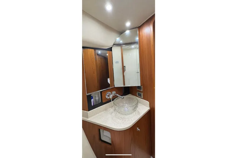 Slide: The Image of Luxurious bathroom in 2007 Tiara 43 yacht with glass sink and wooden cabinetry. - 6