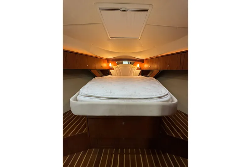 Slide: The Image of Luxurious cabin interior of 2007 Tiara 43 yacht with cozy bed and wooden accents. - 7