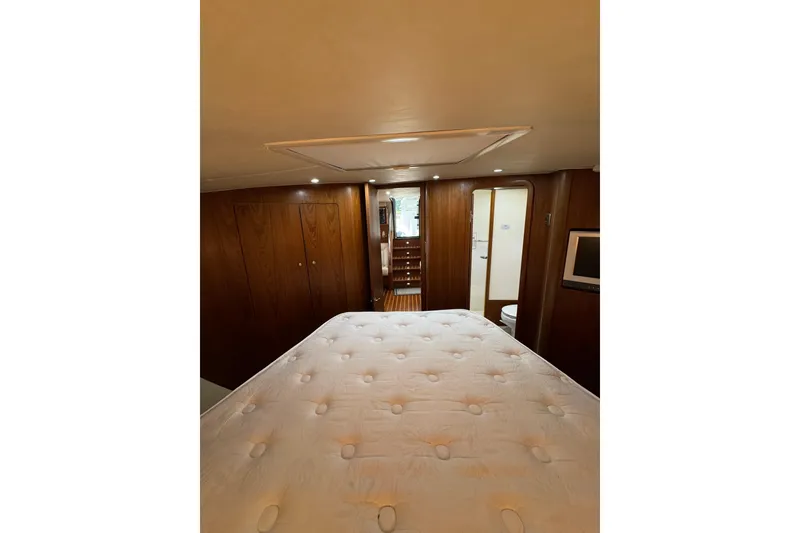 Slide: The Image of Luxurious cabin interior of 2007 Tiara 43 yacht with wood paneling and cozy bed. - 9