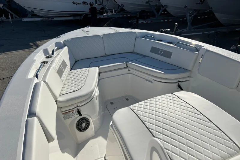 Slide: The Image of 2026 Sea Fox 268 Commander boat interior with white cushioned seating and speaker. - 12