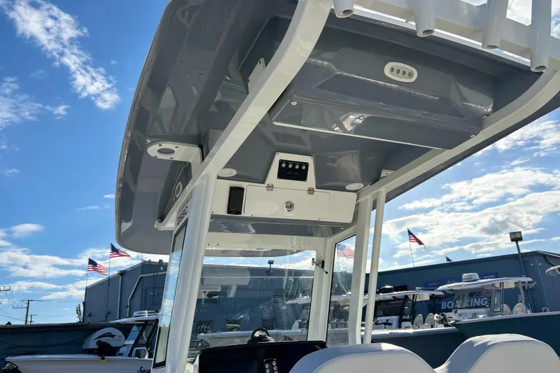 Slide: The Image of 2026 Sea Fox 268 Commander boat interior with T-top under a clear blue sky. - 23