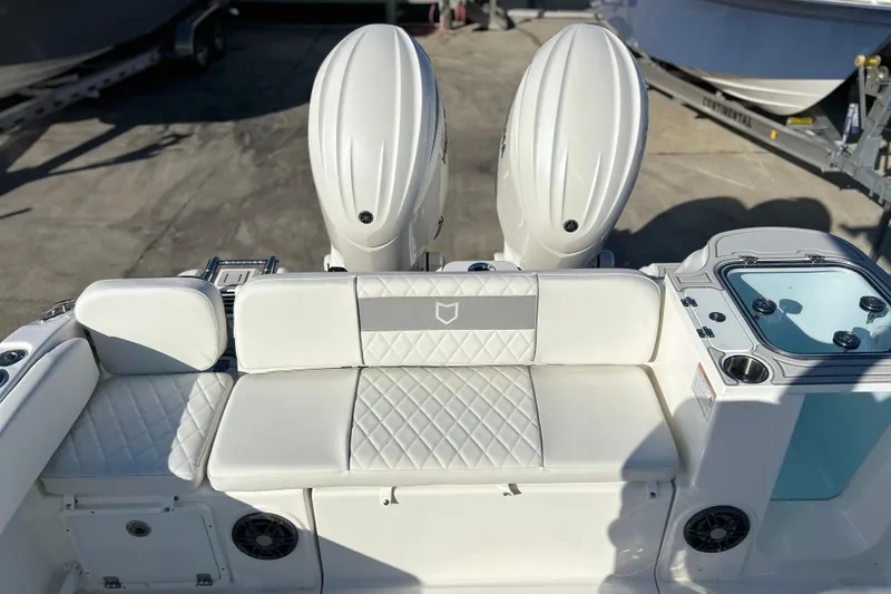 Slide: The Image of 2026 Sea Fox 268 Commander boat interior with dual engines and cushioned seating. - 29