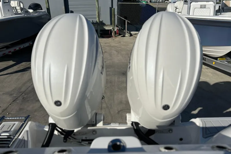 Slide: The Image of Twin outboard engines on a 2026 Sea Fox 268 Commander boat, docked outdoors. - 37