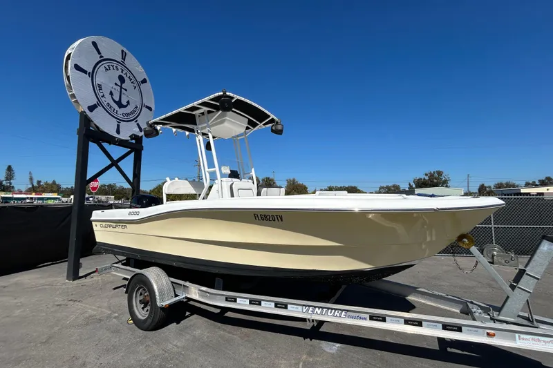 The Image of 2020 Clearwater 2000 Center Console boat on trailer under clear blue sky. - 0