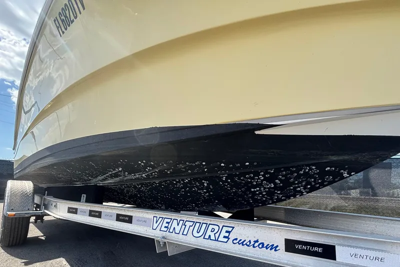 Slide: The Image of 2020 Clearwater 2000 Center Console boat on Venture trailer, close-up view. - 102