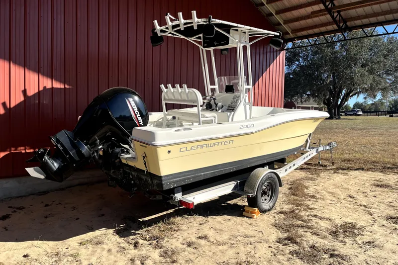 Slide: The Image of 2020 Clearwater 2000 Center Console boat on trailer, featuring Mercury engine. - 2