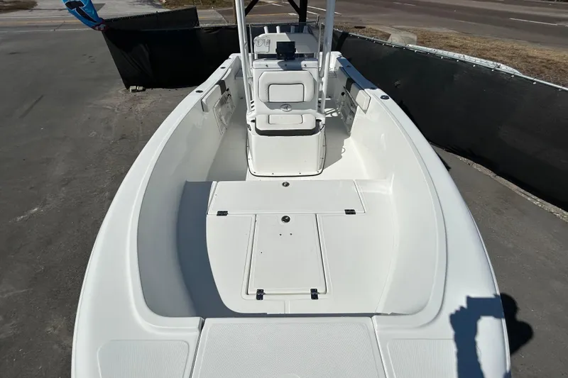 Slide: The Image of 2020 Clearwater 2000 Center Console boat, white interior, docked on pavement. - 22