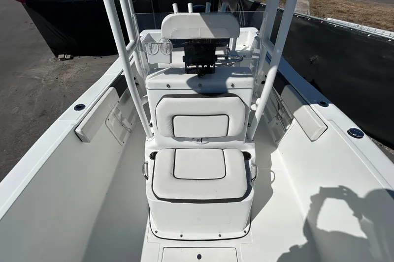Slide: The Image of 2020 Clearwater 2000 Center Console boat interior with white seating and steering console. - 25