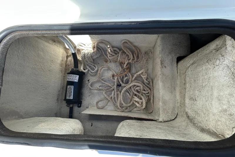 Slide: The Image of Storage compartment of 2020 Clearwater 2000 Center Console boat with rope and pump. - 34