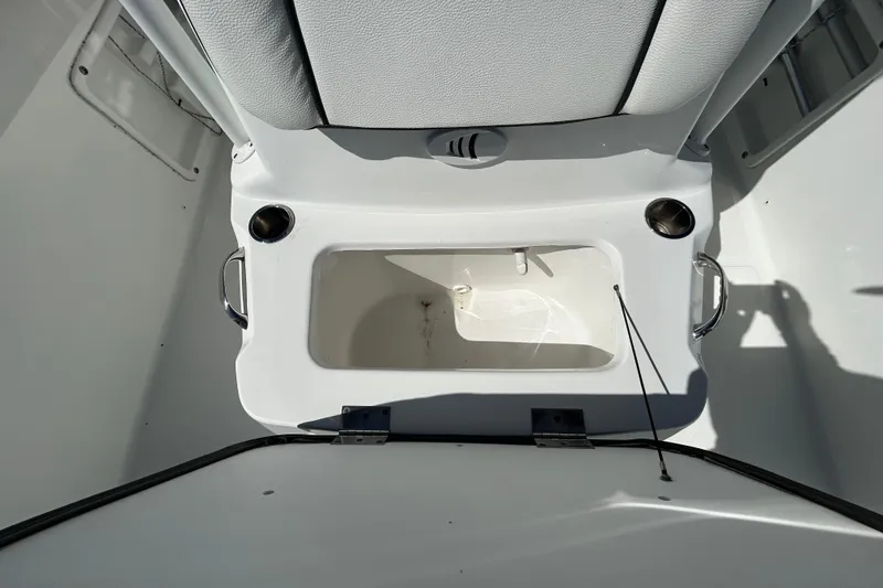 Slide: The Image of 2020 Clearwater 2000 Center Console boat interior with storage compartment and cup holders. - 52