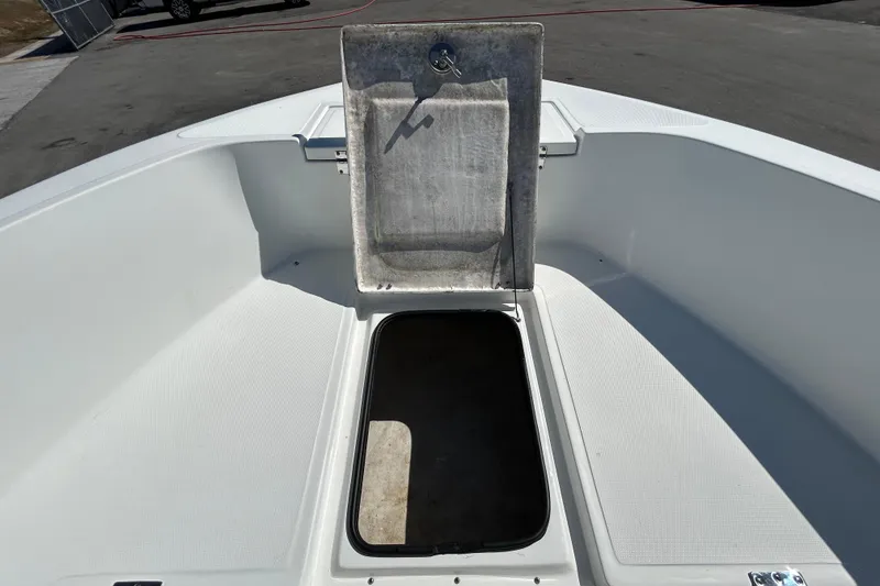 Slide: The Image of 2020 Clearwater 2000 Center Console boat with open storage compartment on deck. - 62