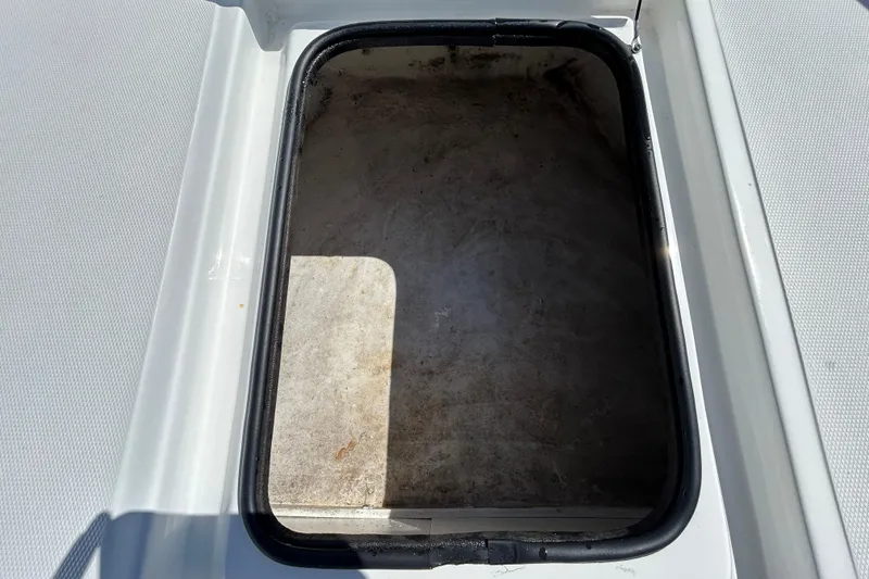 Slide: The Image of Open storage compartment on a 2020 Clearwater 2000 Center Console boat. - 63