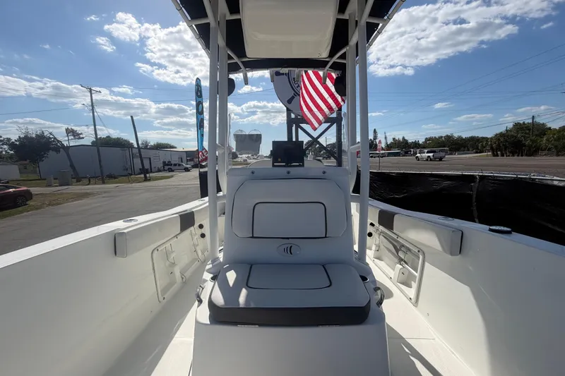 Slide: The Image of 2020 Clearwater 2000 Center Console boat interior with American flag, under clear sky. - 75