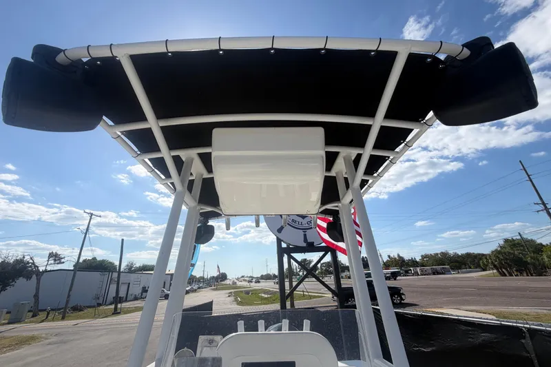 Slide: The Image of 2020 Clearwater 2000 Center Console boat with T-top and speakers, under a clear sky. - 76