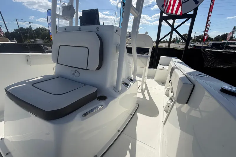 Slide: The Image of 2020 Clearwater 2000 Center Console boat interior with seating and console, under sunny sky. - 77
