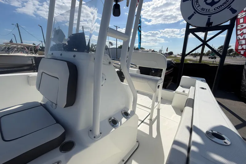 Slide: The Image of 2020 Clearwater 2000 Center Console boat interior with seating and console, under sunny skies. - 78