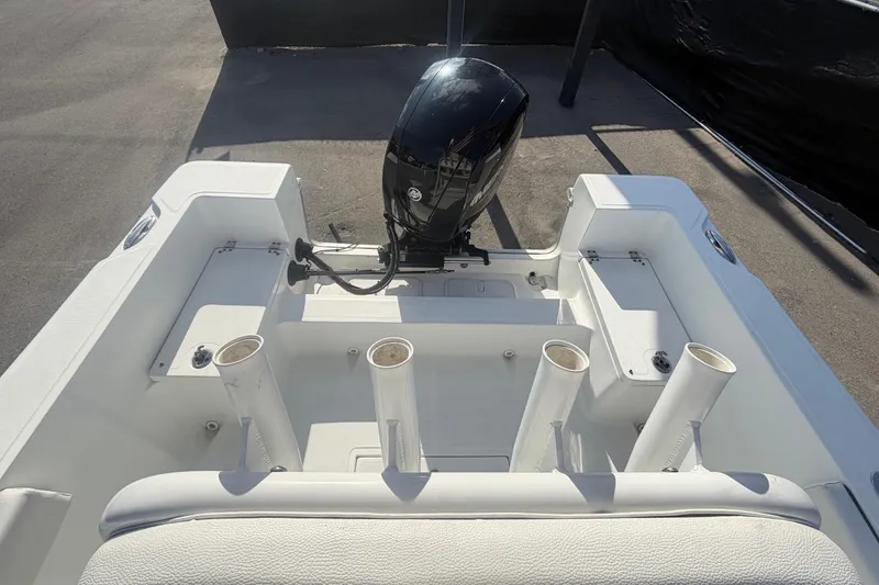 Slide: The Image of 2020 Clearwater 2000 Center Console boat with outboard motor and rod holders. - 88