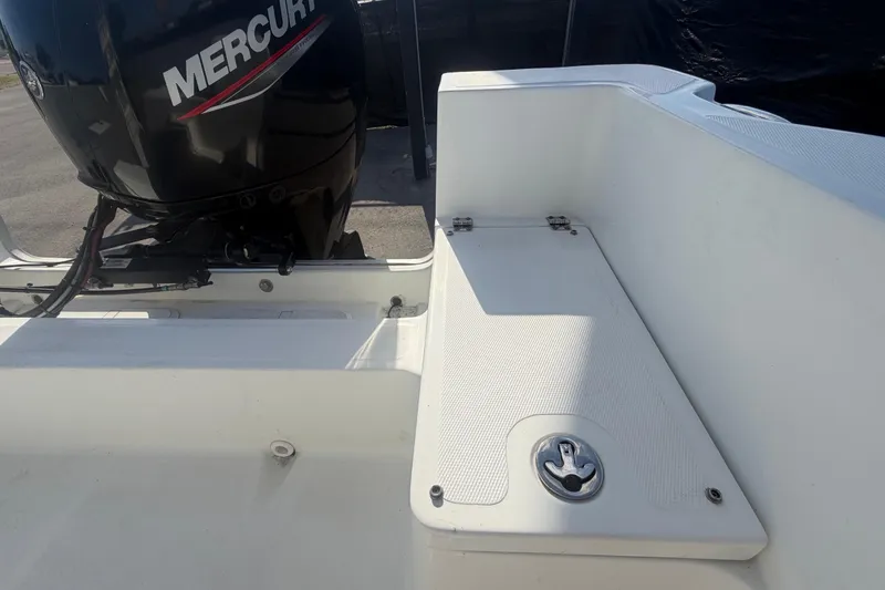 Slide: The Image of 2020 Clearwater 2000 Center Console boat with Mercury engine, featuring a clean white deck. - 90