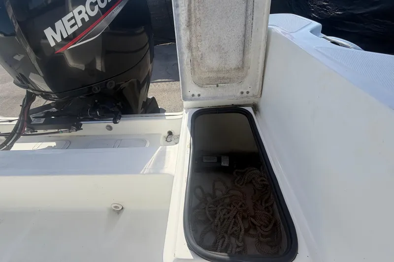 Slide: The Image of Open storage compartment on a 2020 Clearwater 2000 Center Console boat with Mercury engine. - 91