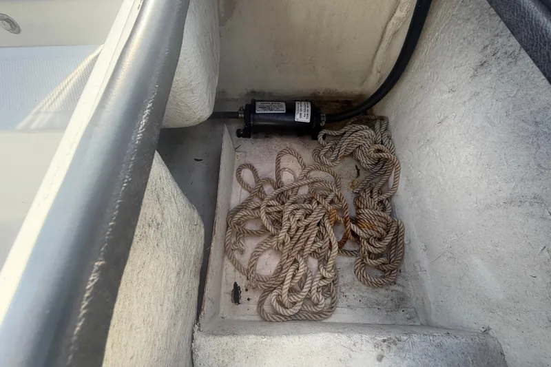 Slide: The Image of Rope and pump inside a 2020 Clearwater 2000 Center Console boat compartment. - 92
