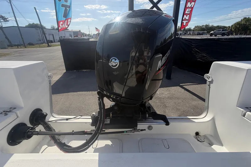 Slide: The Image of 2020 Clearwater 2000 Center Console boat with Mercury outboard motor, displayed outdoors. - 98