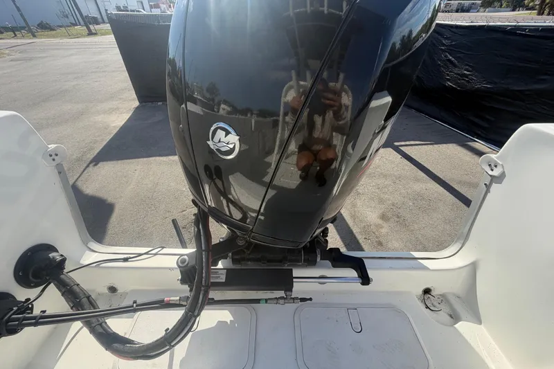 Slide: The Image of 2020 Clearwater 2000 Center Console boat engine, parked outdoors, reflecting surroundings. - 99
