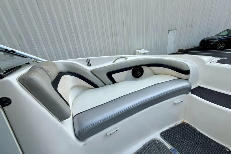Slide: The Image of 2010 Yamaha Boats 212X interior seating with gray and white upholstery. - 6