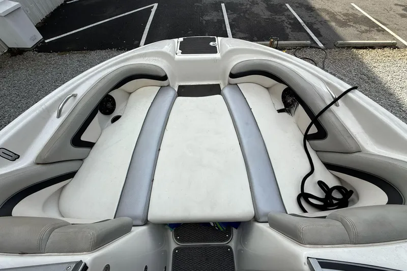 Slide: The Image of 2010 Yamaha Boats 212X interior with white cushioned seating and black accents. - 7