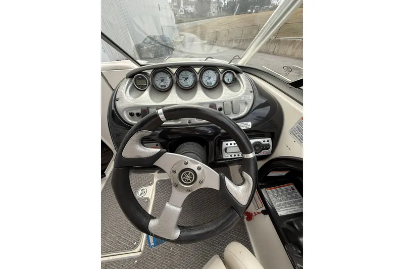 Slide: The Image of Steering wheel and dashboard of 2010 Yamaha Boats 212X, featuring multiple gauges and controls. - 8