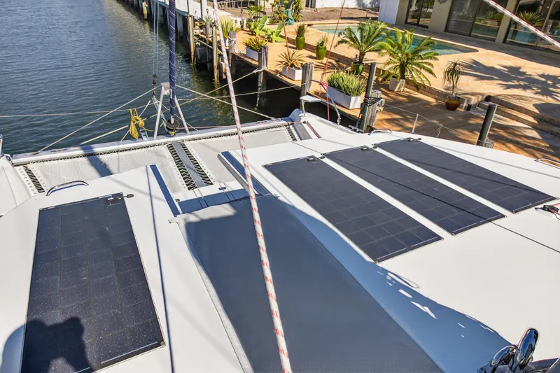 Slide: The Image of 2021 Leopard 50 catamaran with solar panels docked by waterfront. - 100