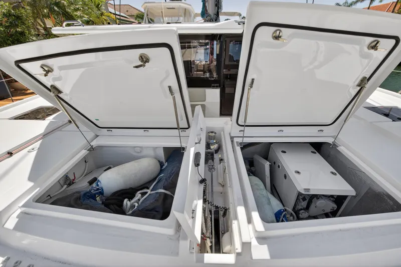 Slide: The Image of Open storage compartments on a 2021 Leopard 50 yacht, showcasing interior equipment and gear. - 104