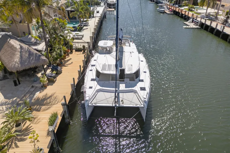 Slide: The Image of Aerial view of 2021 Leopard 50 catamaran docked by a tropical waterfront. - 124