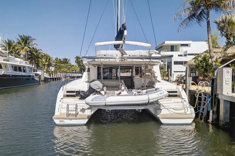 Slide: The Image of 2021 Leopard 50 catamaran docked in a sunny marina with palm trees. - 128