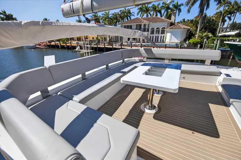 Slide: The Image of Luxurious Leopard 50 yacht deck with seating, table, and waterfront view, 2021 model. - 13