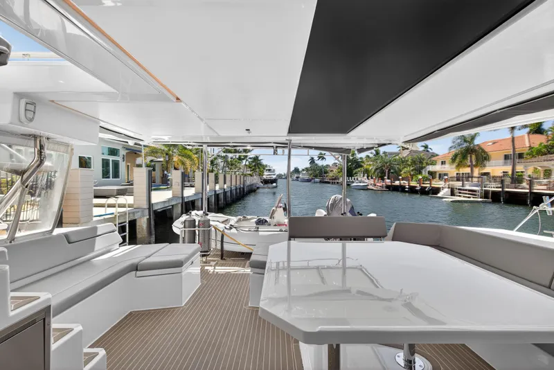 Slide: The Image of Luxurious Leopard 50 yacht interior with waterfront view, featuring modern seating and sleek design, 2021 model. - 26