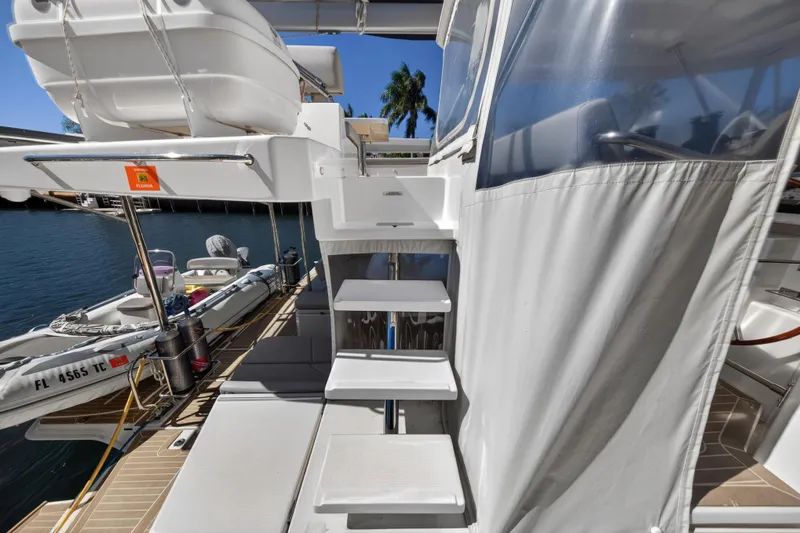 Slide: The Image of Stairs on a 2021 Leopard 50 yacht, docked with inflatable boat nearby. - 29