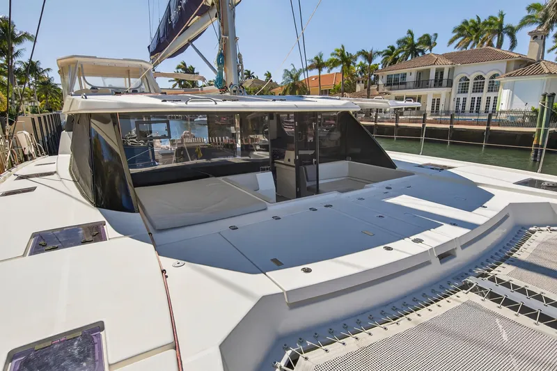 Slide: The Image of Luxurious 2021 Leopard 50 catamaran docked near waterfront homes, showcasing spacious deck. - 41