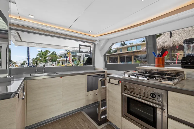 Slide: The Image of Modern kitchen interior on a 2021 Leopard 50 yacht, featuring sleek appliances and ample natural light. - 57